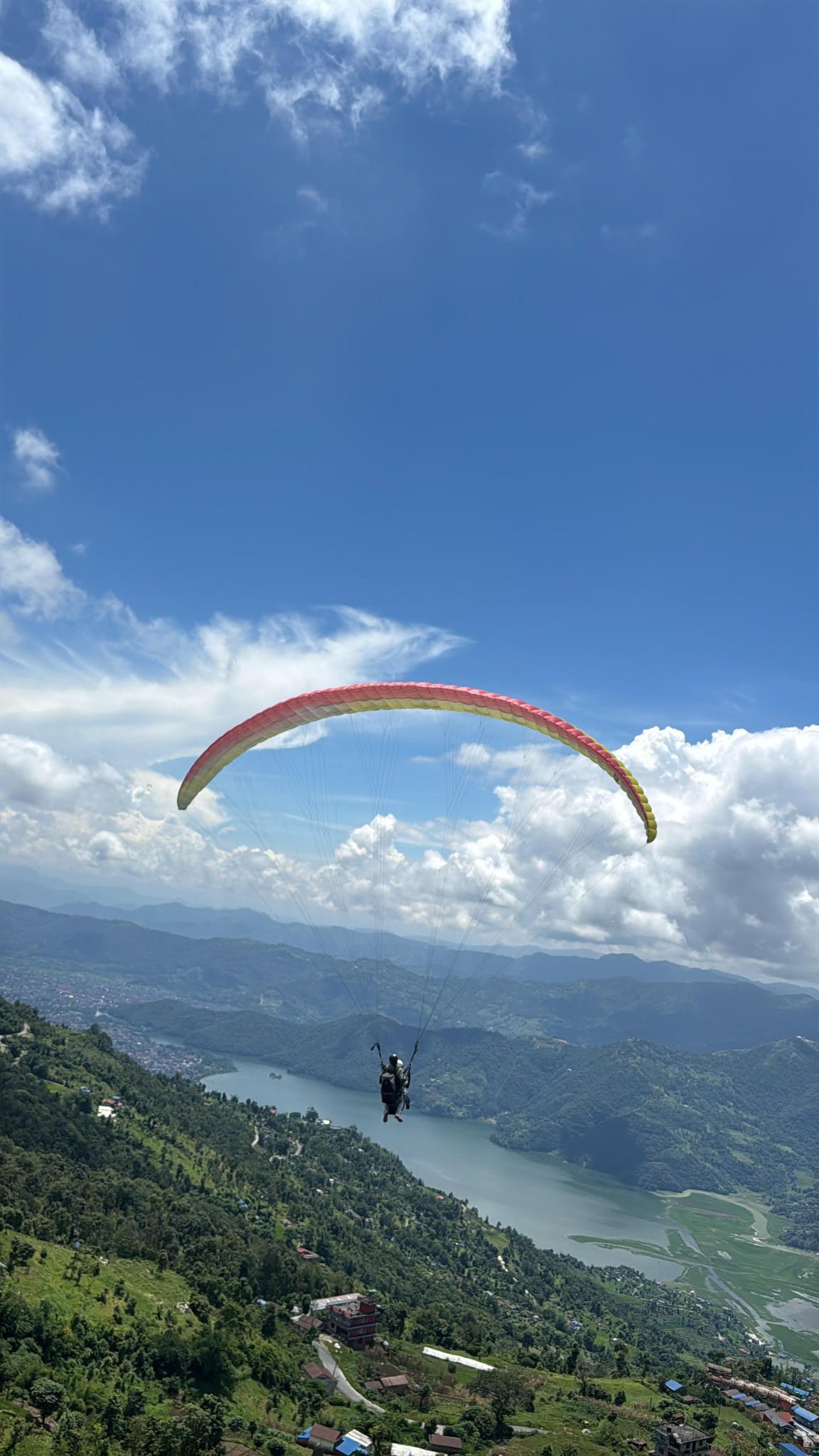 Paraglider flying above Phewa Lake in Pokhara