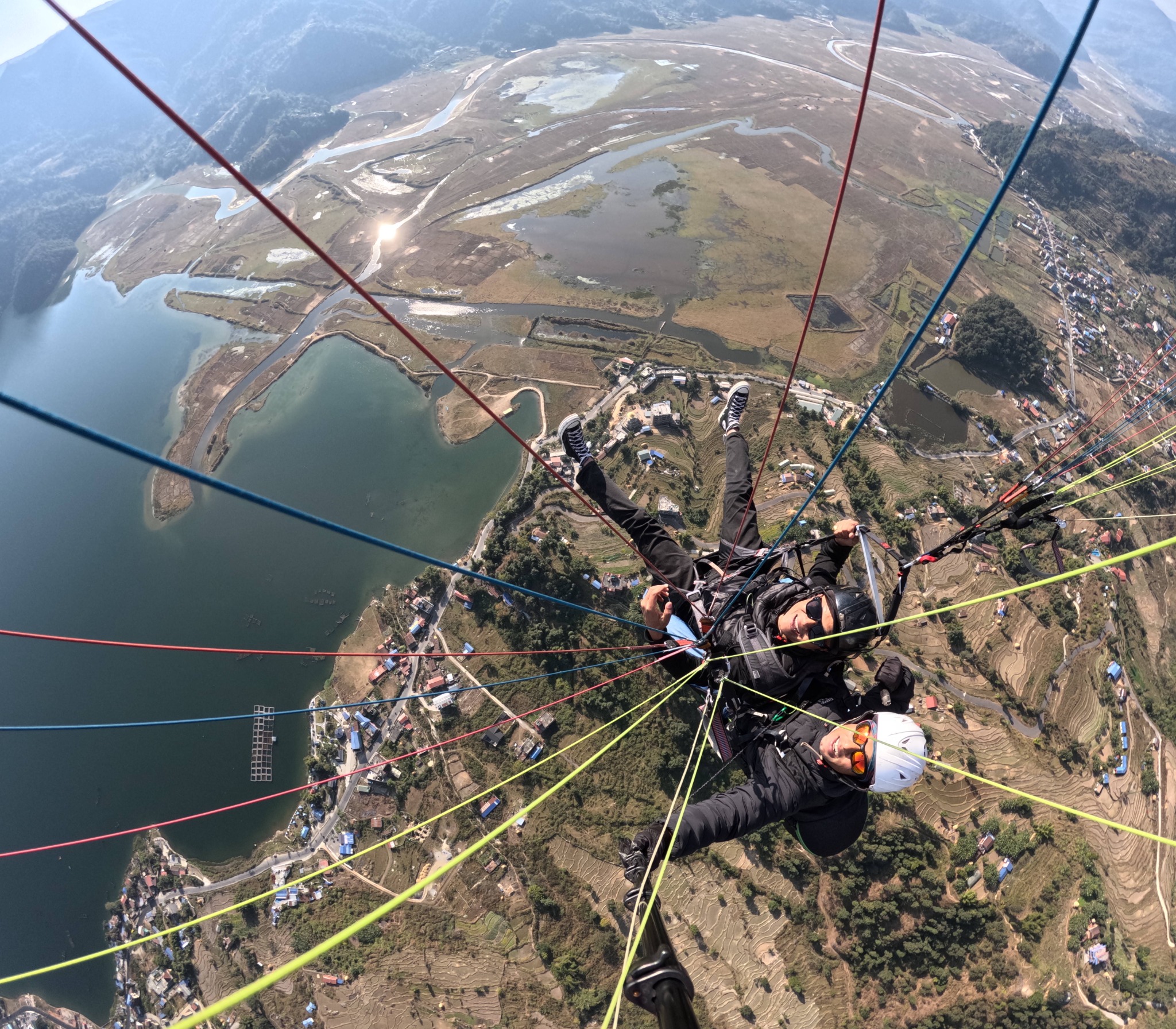 Tandem paragliding selfie above Phewa Lake