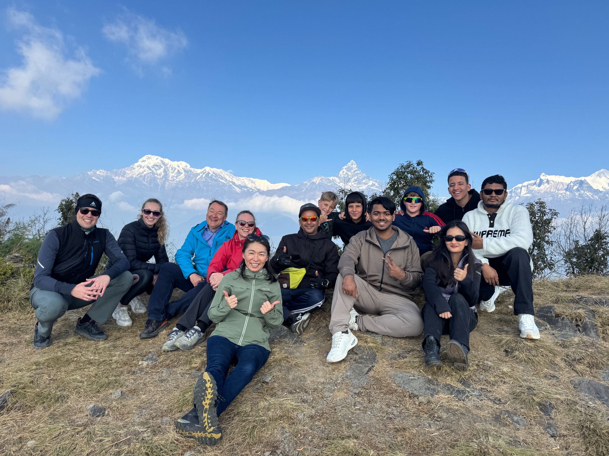 Happy travellers in front of Himalayan mountains